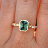 1.27ct Radiant Cut Madagascar Teal Sapphire Low Profile Bezel Solitaire Ring with French Set Diamonds in 14k Yellow Gold