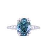 3.94ct Oval Unheated Deep Teal Blue Australian Sapphire Double Claw Prong Low Profile Milgrain and Diamond Ring in Platinum