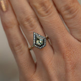0.70ct Shield Cut Montana Sapphire and Blackened Gold Bezel Set Diamond Halo In 14k Green Gold