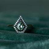 0.70ct Shield Cut Montana Sapphire and Blackened Gold Bezel Set Diamond Halo In 14k Green Gold