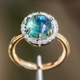 4.48ct Oval Cabochon Parti Sapphire and Blackened Halo ring in 18k Yellow Gold