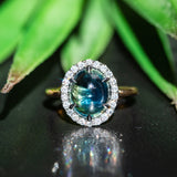 4.48ct Oval Cabochon Parti Sapphire and Blackened Halo ring in 18k Yellow Gold