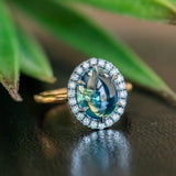 4.48ct Oval Cabochon Parti Sapphire and Blackened Halo ring in 18k Yellow Gold