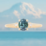 0.85ct Oval Deep Teal Montana Sapphire and Princess Cut Diamond Rapids Low Profile Ring in 14k Yellow Gold