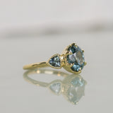 3.93ct Untreated Oval Teal Montana Sapphire and Trillion Australian Sapphire Three Stone Scallop Cup Antique Style with Milgrain Low Profile Ring in 18k Yellow Gold