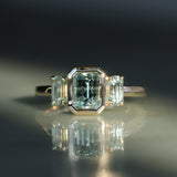 1.29ct Bezel Set Emerald Cut Untreated Montana Sapphire and Montana Sapphire Sides Three Stone Ring in 14k Yellow Gold