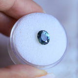 1.73CT PRECISION CUT OVAL MONTANA SAPPHIRE, DENIM PARTI TEAL WITH EARTHY INCLUSIONS, 7.47X6.16X4.69MM