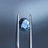1.73CT PRECISION CUT OVAL MONTANA SAPPHIRE, DENIM PARTI TEAL WITH EARTHY INCLUSIONS, 7.47X6.16X4.69MM