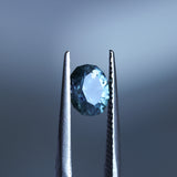 1.73CT PRECISION CUT OVAL MONTANA SAPPHIRE, DENIM PARTI TEAL WITH EARTHY INCLUSIONS, 7.47X6.16X4.69MM