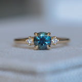 1.10ct Round Deep Teal Montana Sapphire and Princess Cut Diamond Rapids Low Profile Ring in 14k Yellow Gold