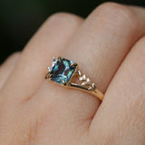 1.65ct Teal Blue Radiant Cut Madagascar Sapphire in Wandering Vine Low Profile 4 Prong Setting with Diamonds in 14k Yellow