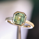 2.18ct Emerald Cut Parti Madagascar Sapphire Low Profile Bezel Solitaire Ring with Pavé Set Diamonds in 14k Green Gold