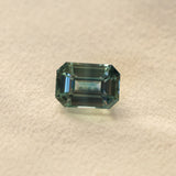 6.91CT UNTREATED EMERALD CUT MADAGASCAR SAPPHIRE, AQUA BLUE GREEN-GREY, 12.1X8.6X6.3MM