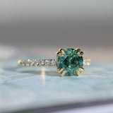 1.97ct Untreated Round Nigerian Teal Green Sapphire Double Prong Solitaire with Pave Set Diamonds in 18k Yellow Gold