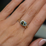 1.52ct Untreated Oval Brilliant Nigerian Parti Sapphire East-West Bezel Solitaire Alluvial Style Ring in 14k Green Gold