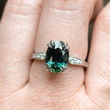 4.26ct Oval Deep Teal Madagascar Sapphire Double Claw Prong Low Profile Milgrain and Diamond Ring in Platinum