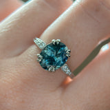 3.94ct Oval Unheated Deep Teal Blue Australian Sapphire Double Claw Prong Low Profile Milgrain and Diamond Ring in Platinum