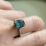 3.94ct Oval Unheated Deep Teal Blue Australian Sapphire Double Claw Prong Low Profile Milgrain and Diamond Ring in Platinum