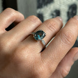 3.94ct Oval Unheated Deep Teal Blue Australian Sapphire Double Claw Prong Low Profile Milgrain and Diamond Ring in Platinum