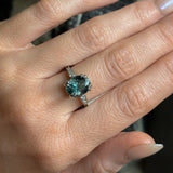 3.94ct Oval Unheated Deep Teal Blue Australian Sapphire Double Claw Prong Low Profile Milgrain and Diamond Ring in Platinum