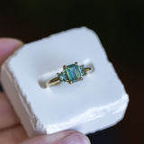 1.30ct Emerald Cut Madagascar Sapphire and 0.98ctw Montana Sapphire Three Stone Low Profile Ring in 18k Yellow Gold
