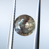 1.50CT ROUND MADAGASCAR SAPPHIRE, BROWN WITH ORANGE AND GREEN FLASHES, 6.7MM