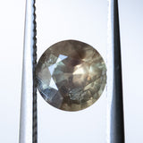 1.50CT ROUND MADAGASCAR SAPPHIRE, BROWN WITH ORANGE AND GREEN FLASHES, 6.7MM