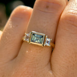 1.06ct Unheated Step Cut Teal Bezel Set Sapphire and White Cadillac Prong Set Sapphire Low Profile Three Stone Ring in 14k Yellow Gold