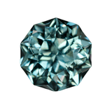 A single round brilliant-cut gemstone with a light blue-green, teal hue, isolated on a solid white background.