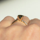 1.01ct Round Earthy Sapphire Evergreen Solitaire in 14k Yellow Gold on hand