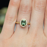 1.38ct Oval Green Montana Sapphire 18k Yellow Satin Evergreen Halo Ring on hand