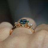 1.54ct Oval Montana Sapphire and Diamond Three Stone Ring in 14k Yellow Gold on hand