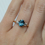 1.54ct Oval Montana Sapphire and Diamond Three Stone Ring in 14k Yellow Gold on hand