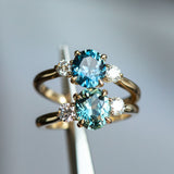 1.54ct Oval Montana Sapphire and Diamond Three Stone Ring in 14k Yellow Gold in tweezers