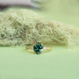 1.80ct Oval Nigerian Parti Sapphire Vintage Cathedral Ring in 14k Yellow Gold on table with moss