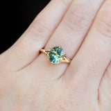 2.40ct Oval Teal Green Parti Sapphire Evergreen Carved Split Shank Six Prong Ring in 14k Yellow Gold on hand