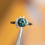 2.04ct Australian Teal Sapphire and Asymmetrical Diamond Cluster Ring in 14k Yellow and 14k White Gold in tweezers