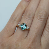 2.11ct Oval Color Shifting Madagascar Sapphire and Diamond Three Stone Ring in 14k Yellow Gold on hand