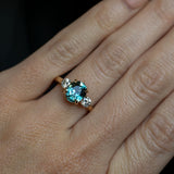 2.11ct Oval Color Shifting Madagascar Sapphire and Diamond Three Stone Ring in 14k Yellow Gold on hand