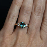 2.11ct Oval Color Shifting Madagascar Sapphire and Diamond Three Stone Ring in 14k Yellow Gold on hand