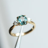 2.11ct Oval Color Shifting Madagascar Sapphire and Diamond Three Stone Ring in 14k Yellow Gold in tweezers