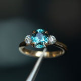 2.11ct Oval Color Shifting Madagascar Sapphire and Diamond Three Stone Ring in 14k Yellow Gold in tweezers