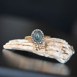 2.40ct Oval Cabochon Montana Sapphire and Antiqued Six Prong Low Profile Halo Ring in 14k Yellow Gold on seashell