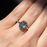2.40ct Oval Cabochon Montana Sapphire and Antiqued Six Prong Low Profile Halo Ring in 14k Yellow Gold on hand