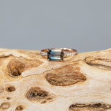 2.56ct Bicolor Sapphire Ombre East West 4-Prong Ring with white and salt & pepper side diamonds in 14k rose gold on wood