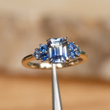 2.02ct Emerald Cut Bicolor Sapphire and Blue Sapphire Side Stone Cluster Ring in Two Tone 14k Yellow and White Gold