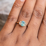 1.47ct Radiant Opalescent Teal Sapphire and White Sapphire Three Stone Ring in 14k Yellow Gold