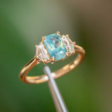 1.47ct Radiant Opalescent Teal Sapphire and White Sapphire Three Stone Ring in 14k Yellow Gold