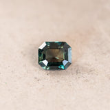 2.06CT EMERALD CUT MADAGASCAR SAPPHIRE, COLOR CHANGING DEEP TEAL TO PURPLE GREY, 7.4X6.32X4.28MM, UNTREATED