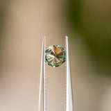 0.68CT ROUND BRILLIANT MONTANA SAPPHIRE, COLOR SHIFTING BLUE GREY TO SPRING GREEN, 5.49X3.25MM